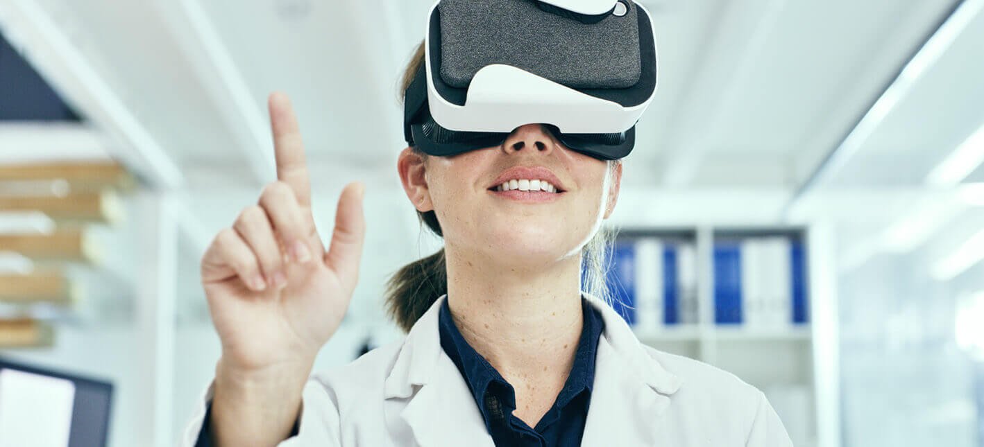 Cientista da Petrobras com óculos de realidade virtual. Ela está com o dedo levantado para cima.